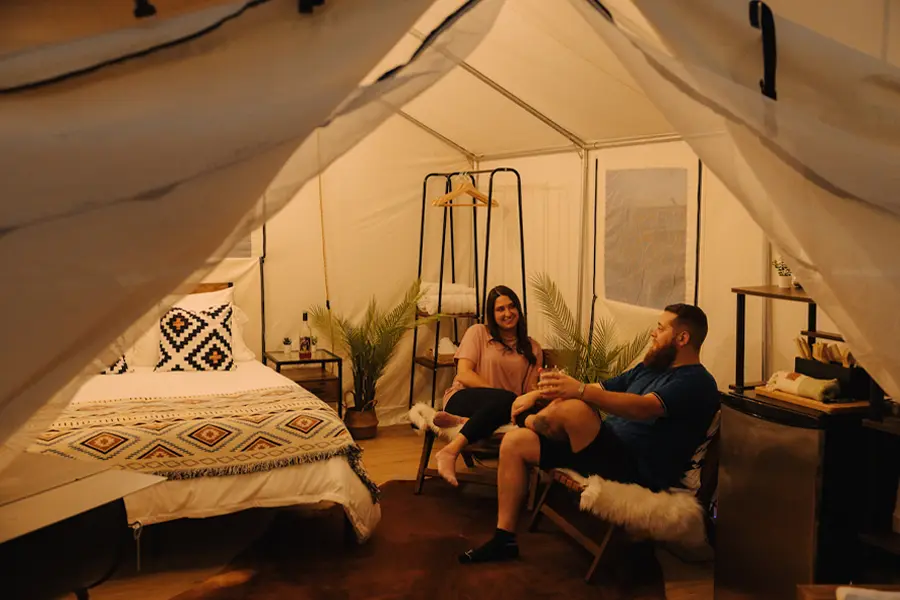 glamping at rustic acres rv resort and campground couple inside yurt talking